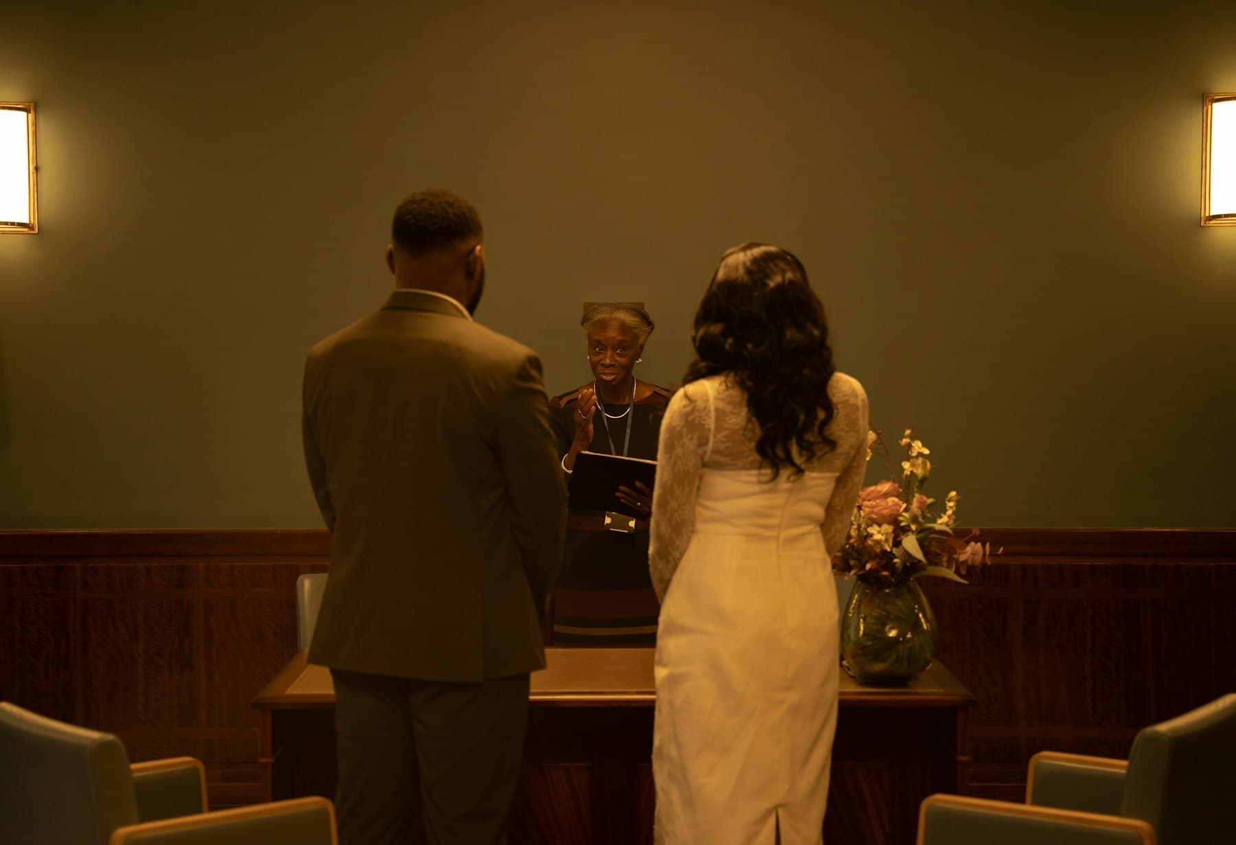 A couple standing together at a small registry office ceremony